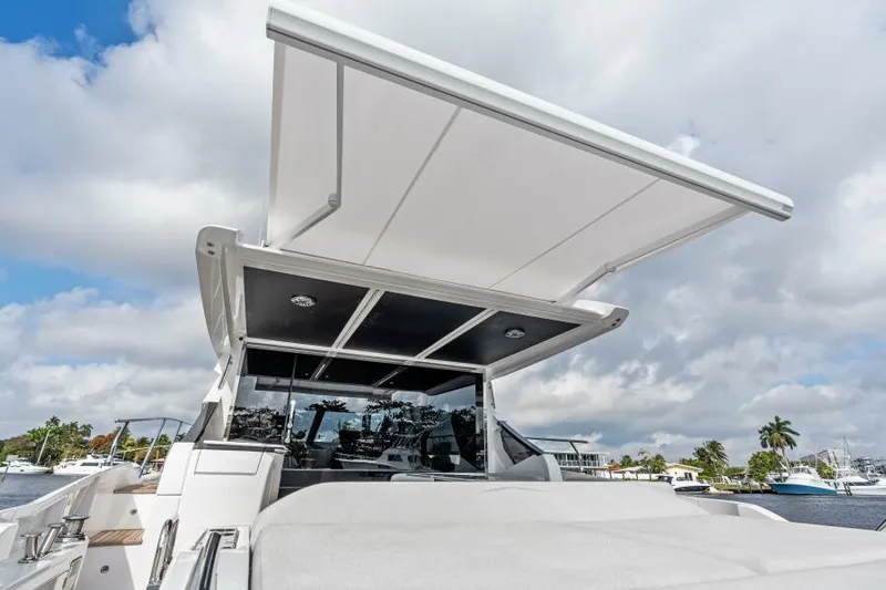 Blessed Yacht Photos Pics 2020 Azimut S6 yacht with extended sunshade, docked under a partly cloudy sky.