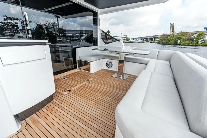 Blessed Yacht Photos Pics Azimut S6 2020 yacht deck with white seating and wooden flooring.