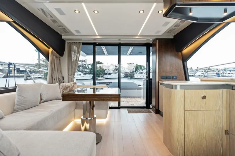 Blessed Yacht Photos Pics Luxurious interior of 2020 Azimut S6 yacht with modern furnishings and large windows.