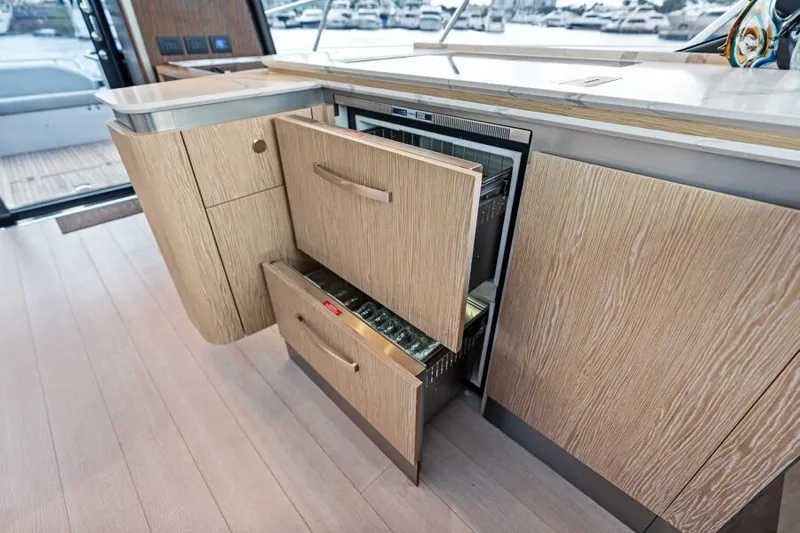 Blessed Yacht Photos Pics Modern kitchen area on 2020 Azimut S6 yacht with open drawers and sleek design.
