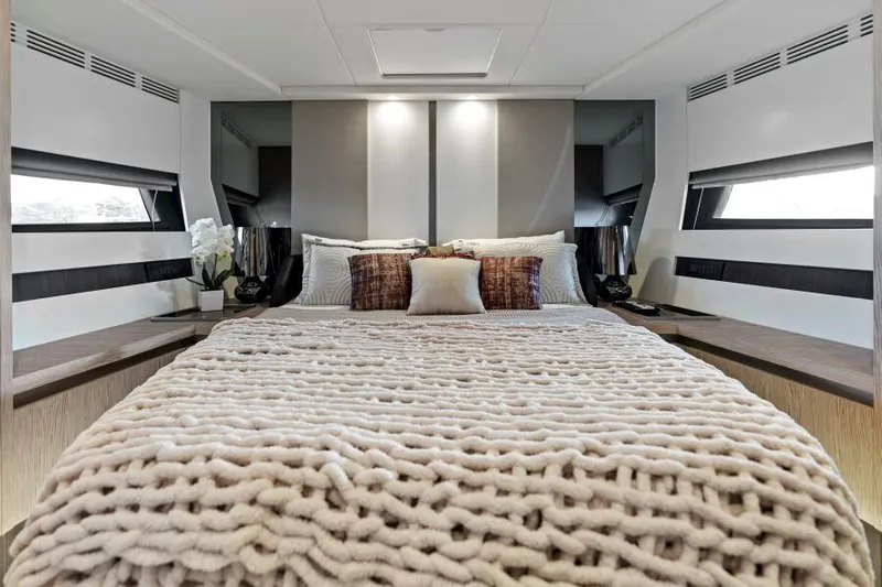 Blessed Yacht Photos Pics Luxurious bedroom interior of 2020 Azimut S6 yacht with plush bedding and modern design.