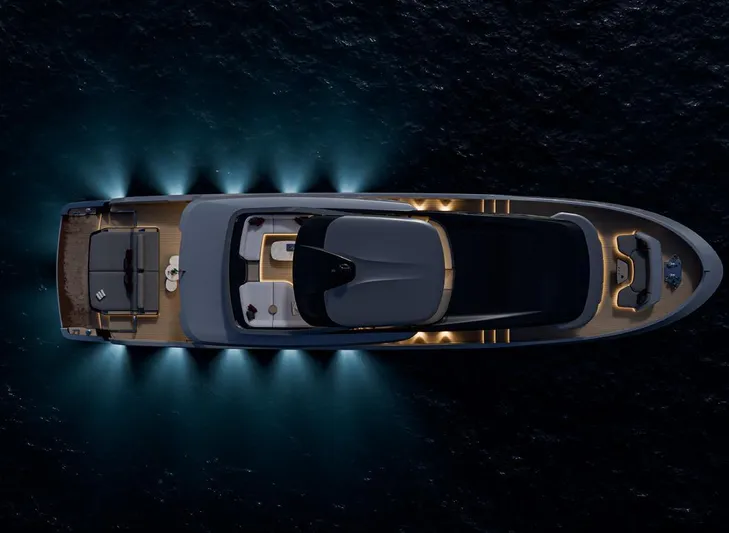 X106 Fast Yacht Photos Pics Aerial view of 2026 Extra X 106 FAST yacht illuminated on dark water.