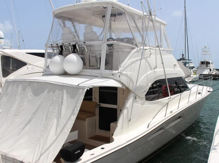  Yacht Photos Pics 2005 Riviera 51 Flybridge yacht docked at marina.