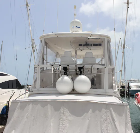  Yacht Photos Pics 2005 Riviera 51 Flybridge yacht docked at marina, rear view.