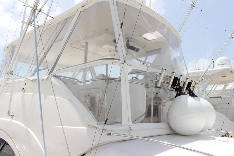  Yacht Photos Pics 2005 Riviera 51 Flybridge yacht with enclosed helm and fishing rod holders.