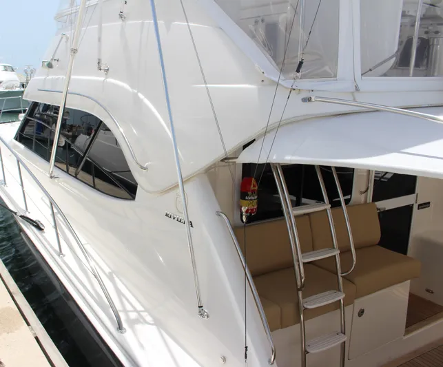  Yacht Photos Pics 2005 Riviera 51 Flybridge yacht with white exterior and beige seating.