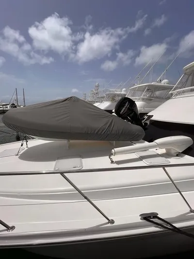  Yacht Photos Pics 2005 Riviera 51 Flybridge yacht docked at marina under cloudy sky.