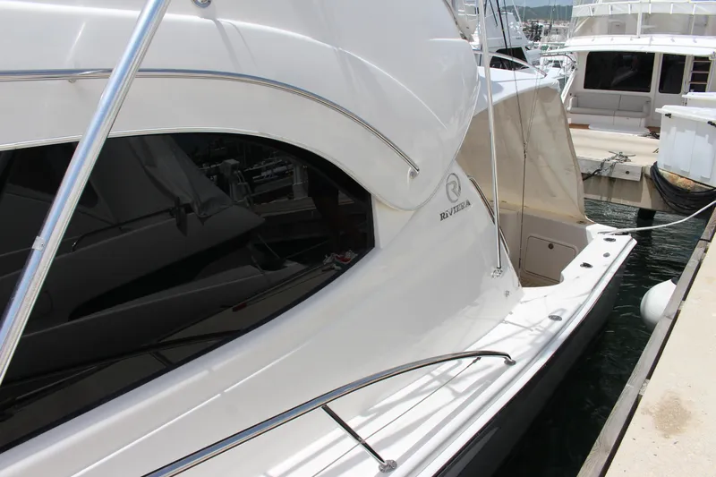  Yacht Photos Pics 2005 Riviera 51 Flybridge yacht docked at a marina.