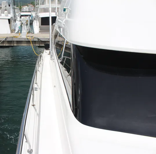  Yacht Photos Pics 2005 Riviera 51 Flybridge yacht docked at a marina.