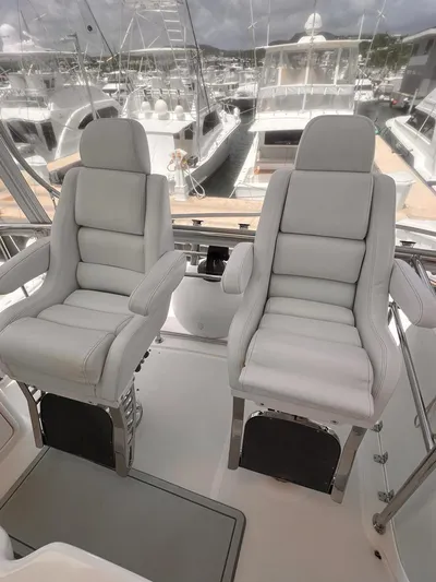  Yacht Photos Pics 2005 Riviera 51 Flybridge helm seats with marina view.