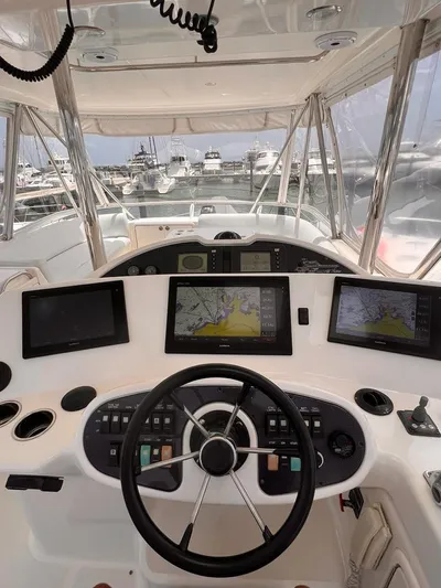  Yacht Photos Pics 2005 Riviera 51 Flybridge helm with navigation screens and controls.