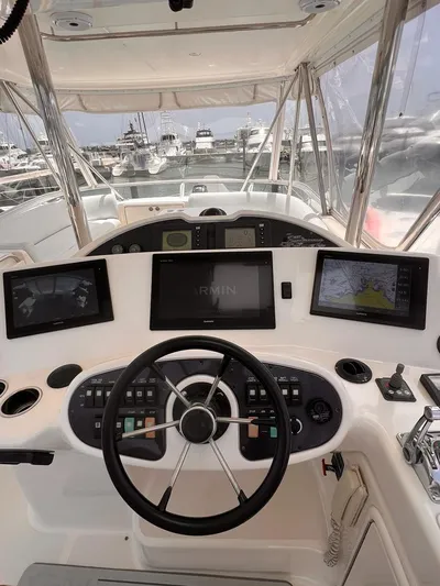  Yacht Photos Pics 2005 Riviera 51 Flybridge helm with modern navigation screens and controls.