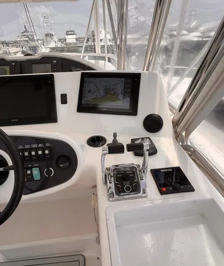  Yacht Photos Pics 2005 Riviera 51 Flybridge helm with navigation screens and controls.