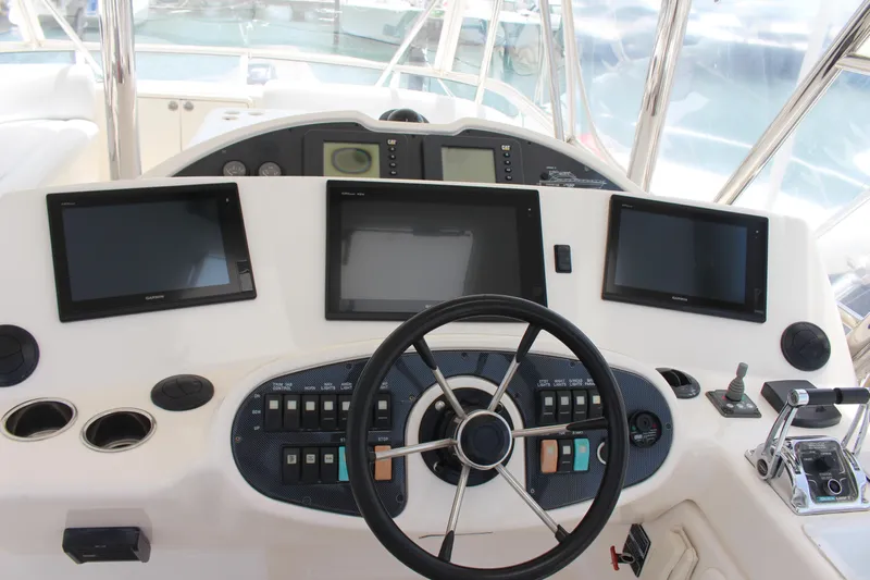  Yacht Photos Pics Helm station of a 2005 Riviera 51 Flybridge yacht with modern navigation equipment.