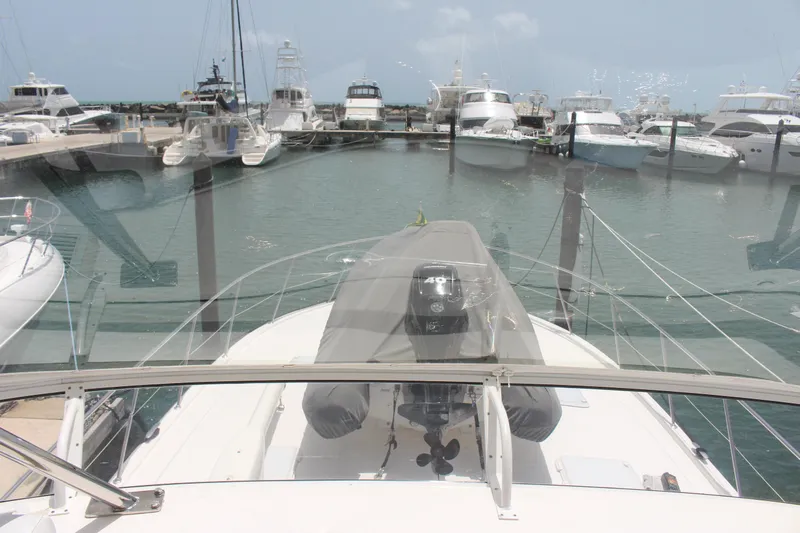  Yacht Photos Pics 2005 Riviera 51 Flybridge yacht docked at a marina with other boats.