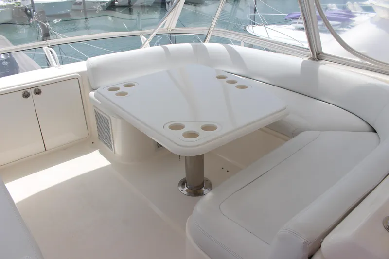 Yacht Photos Pics 2005 Riviera 51 Flybridge yacht interior with white seating and table.