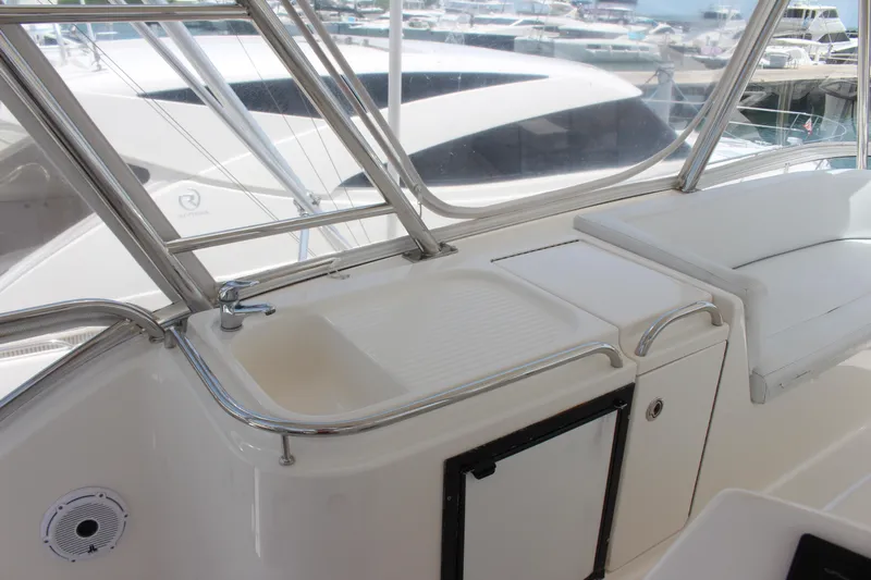  Yacht Photos Pics 2005 Riviera 51 Flybridge yacht interior with sink and seating area.