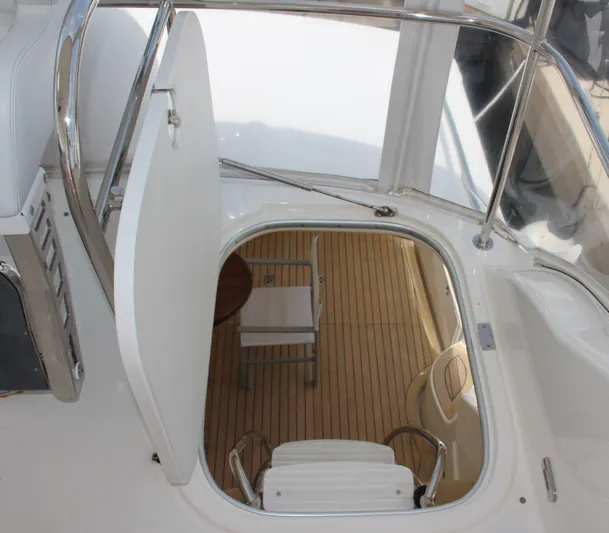  Yacht Photos Pics Hatch and stairs leading to the interior of a 2005 Riviera 51 Flybridge yacht.