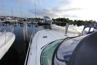 2001 Precision Convertible yacht docked at a marina with other boats.