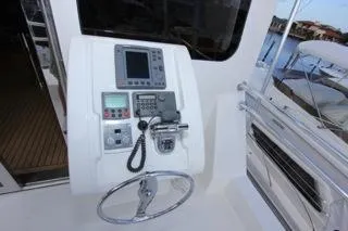 Mabel Yacht Photos Pics 2001 Precision Convertible boat control panel with steering wheel and navigation equipment.