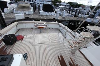2001 Precision Convertible yacht with spacious deck at marina.