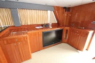 Mabel Yacht Photos Pics Luxurious wooden interior of a 2001 Precision Convertible yacht with built-in TV.