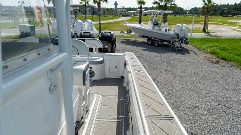  Yacht Photos Pics 2007 Fountain 38TE Cuddy Cabin boat on gravel lot with other boats in background.