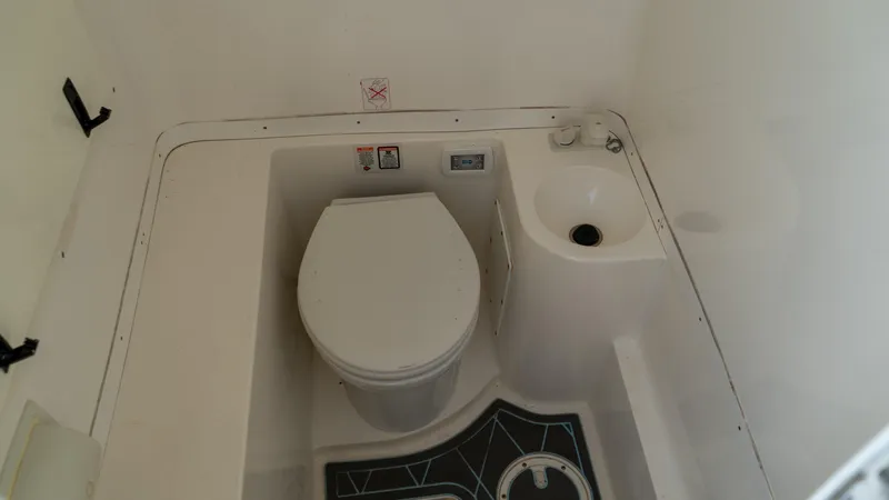  Yacht Photos Pics 2007 Fountain 38TE Cuddy Cabin bathroom with toilet and sink.