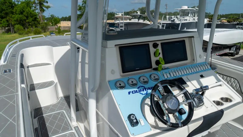  Yacht Photos Pics 2007 Fountain 38TE Cuddy Cabin boat dashboard with dual screens and steering wheel.