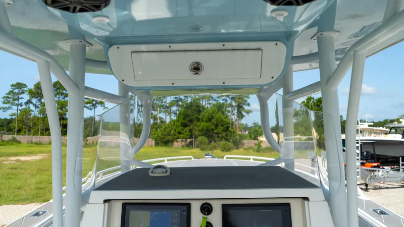  Yacht Photos Pics 2007 Fountain 38TE Cuddy Cabin boat dashboard with navigation screens and overhead storage.