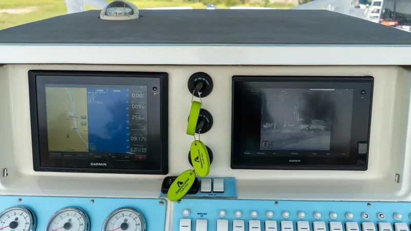  Yacht Photos Pics Control panel of a 2007 Fountain 38TE Cuddy Cabin boat with Garmin navigation displays.