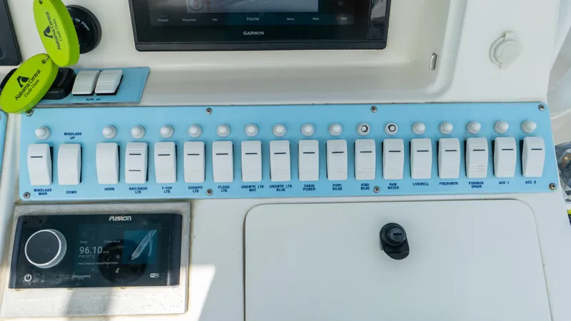  Yacht Photos Pics Control panel of a 2007 Fountain 38TE Cuddy Cabin boat with various switches and displays.