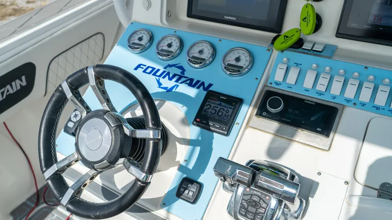  Yacht Photos Pics 2007 Fountain 38TE Cuddy Cabin boat dashboard with steering wheel and control gauges.