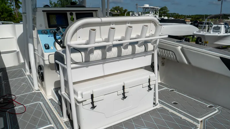  Yacht Photos Pics 2007 Fountain 38TE Cuddy Cabin boat interior with helm, rod holders, and cooler.