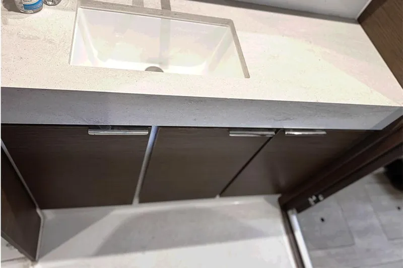 Coquina Yacht Photos Pics Modern bathroom sink with dark wood cabinets in a 2019 Lagoon 40 yacht.