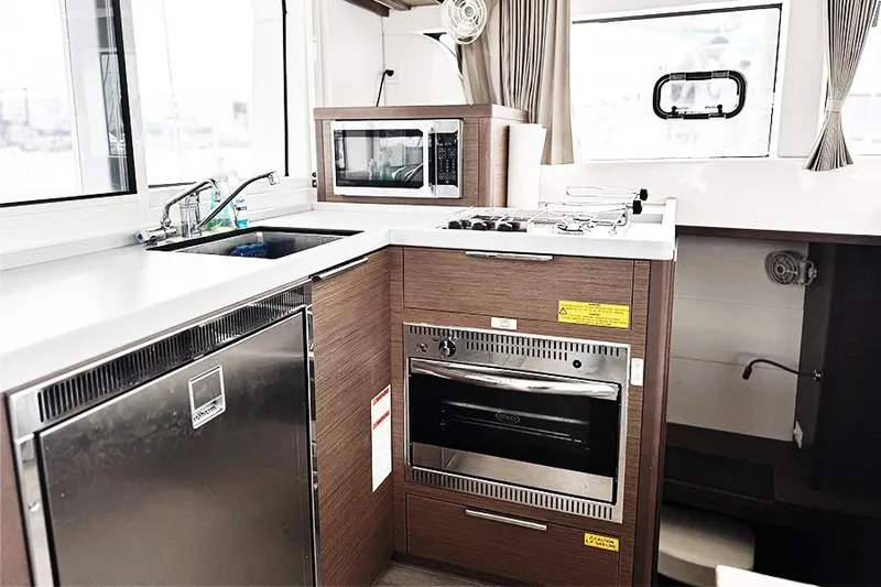 Coquina Yacht Photos Pics Modern kitchen in 2019 Lagoon 40 catamaran with microwave, oven, and sink.