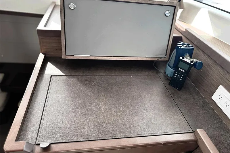 Coquina Yacht Photos Pics Interior workspace of 2019 Lagoon 40 yacht with storage and electronic device.