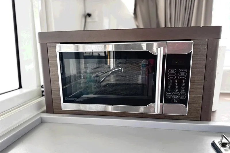 Coquina Yacht Photos Pics Microwave oven inside a 2019 Lagoon 40 catamaran kitchen area.