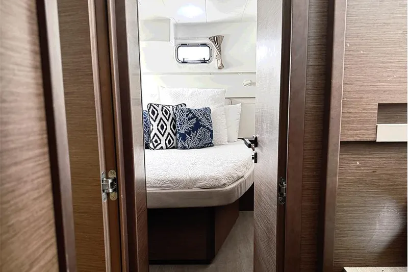 Coquina Yacht Photos Pics Interior cabin of 2019 Lagoon 40 catamaran with cozy bed and decorative pillows.