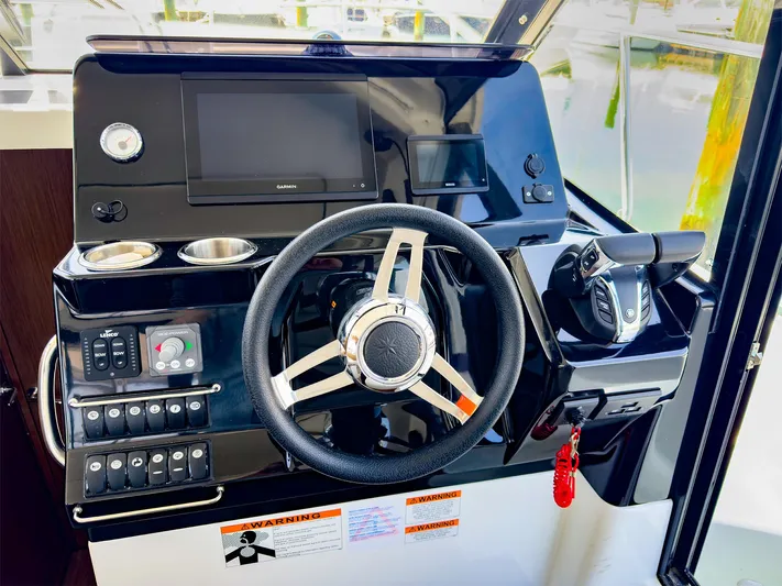 4761ak Yacht Photos Pics Helm station of 2021 Jeanneau NC 1095 FLY with steering wheel and control panel.