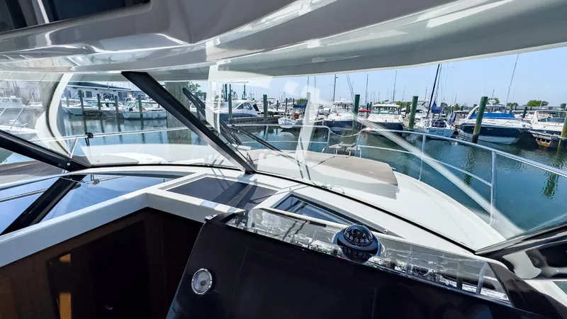 4761ak Yacht Photos Pics Jeanneau NC 1095 FLY 2021 boat interior with marina view through windshield.
