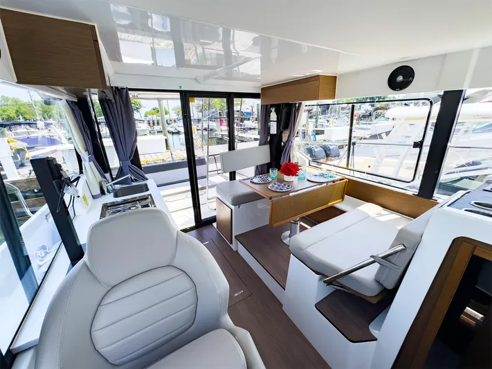 4761ak Yacht Photos Pics Interior of 2021 Jeanneau NC 1095 FLY boat with dining area and helm station.