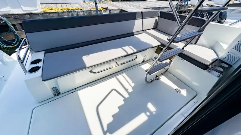 4761ak Yacht Photos Pics 2021 Jeanneau NC 1095 FLY boat interior with seating and ladder.