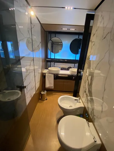  Yacht Photos Pics Luxurious bathroom in 2022 Ferretti Yachts 720, featuring modern fixtures and elegant marble design.