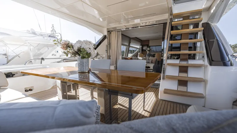  Yacht Photos Pics Luxurious 2022 Ferretti Yachts 720 interior with elegant dining area and modern staircase.