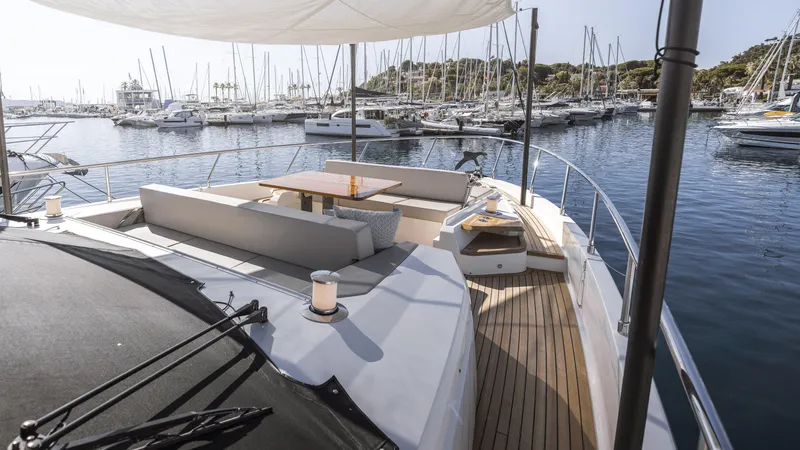  Yacht Photos Pics Luxurious 2022 Ferretti Yachts 720 with elegant deck seating in a marina setting.