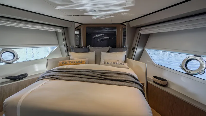  Yacht Photos Pics Luxurious bedroom interior of 2022 Ferretti Yachts 720 with elegant bedding and ocean view.