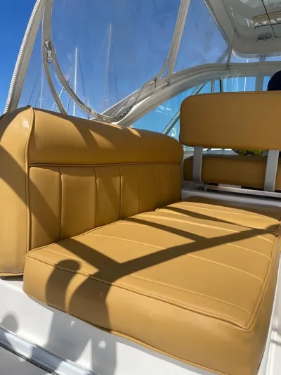  Yacht Photos Pics Tan leather seating on a 2004 Cabo 35 Express boat under clear blue skies.