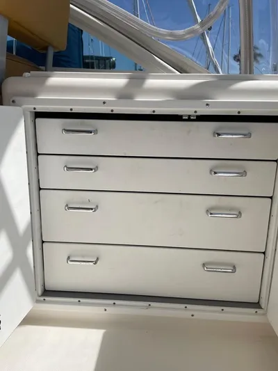  Yacht Photos Pics White storage drawers on a 2004 Cabo 35 Express boat, featuring sleek metal handles.