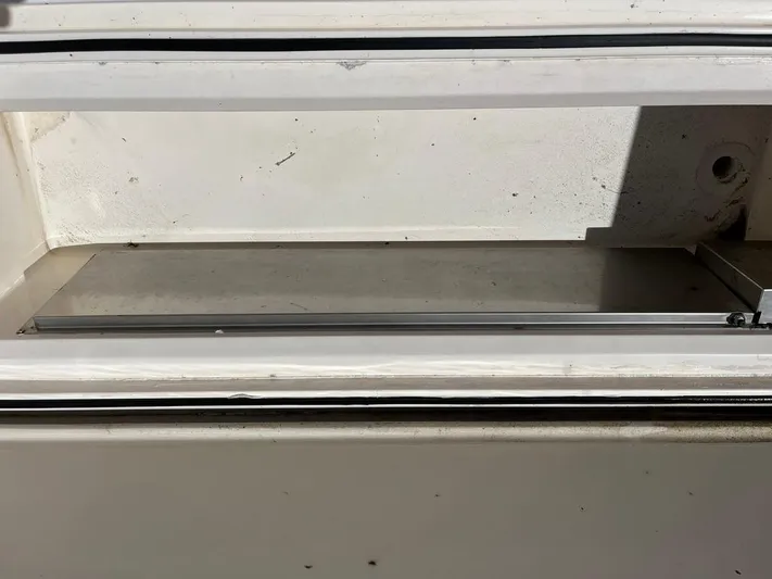  Yacht Photos Pics Storage compartment on a 2004 Cabo 35 Express boat, featuring a clean, white interior.